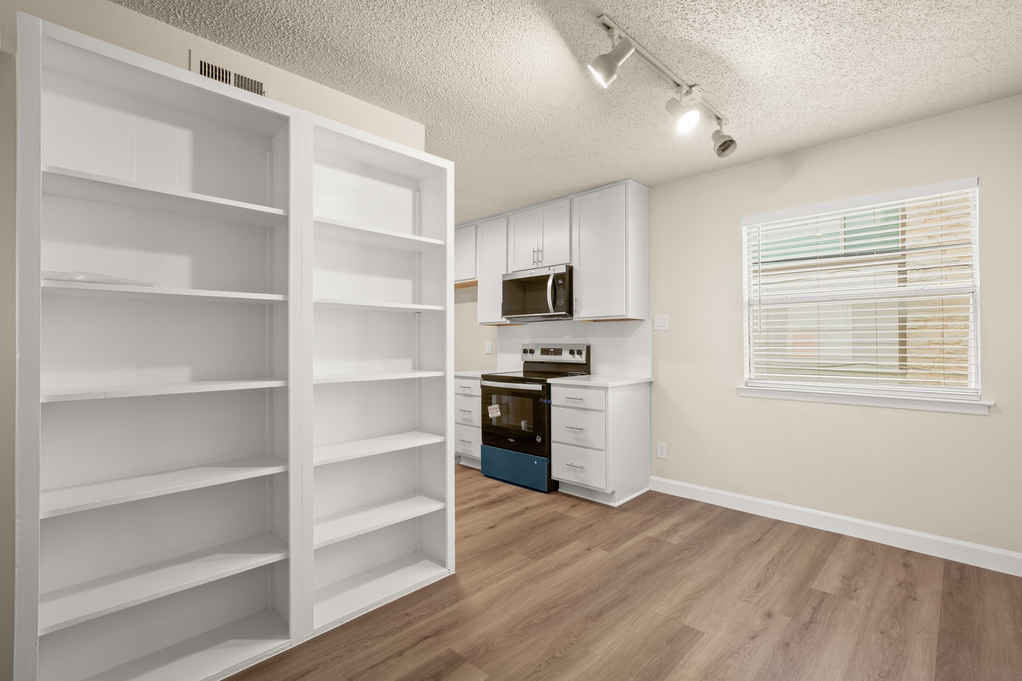 2408 Longview Street, Unit 112 Austin, TX 78705 - Photo 3 of 15 a room with cabinets and window