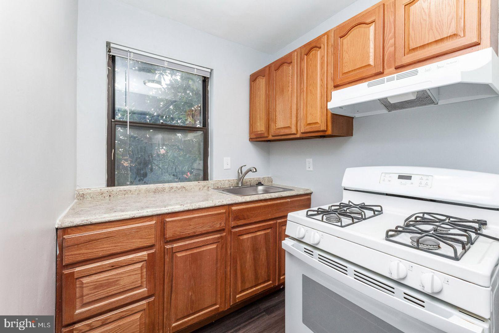 2100 Channing Street Northeast, Unit 2A Washington, DC 20018 - Photo 4 of 8 Cozy kitchen with warm wooden accents.