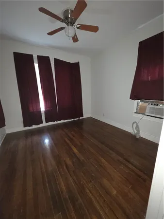 a view of wooden floor and windows in a room
