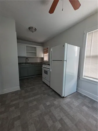a kitchen with refrigerator and window