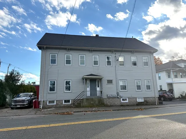 a view of a car park front of a house
