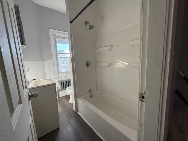 a bathroom with a bathtub and a shower
