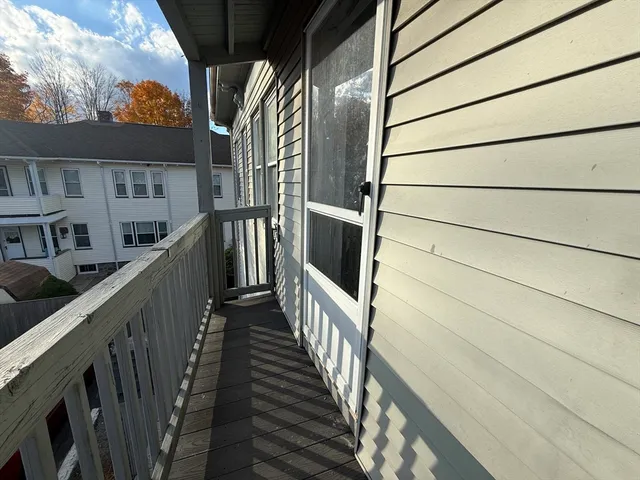 a view of balcony with wooden floor and stairs