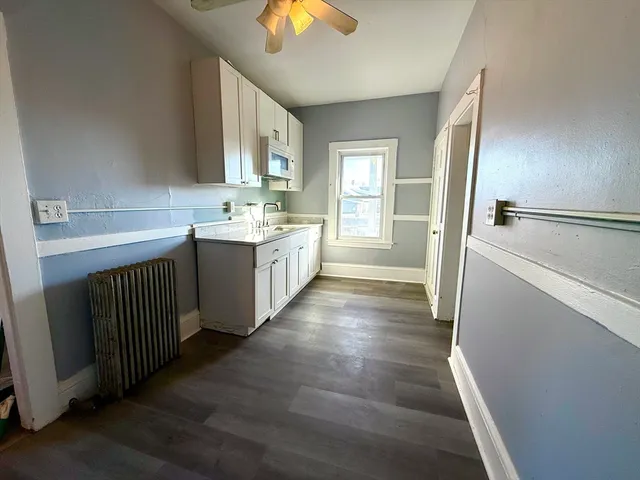 a bathroom with a double vanity sink and mirror with bathtub