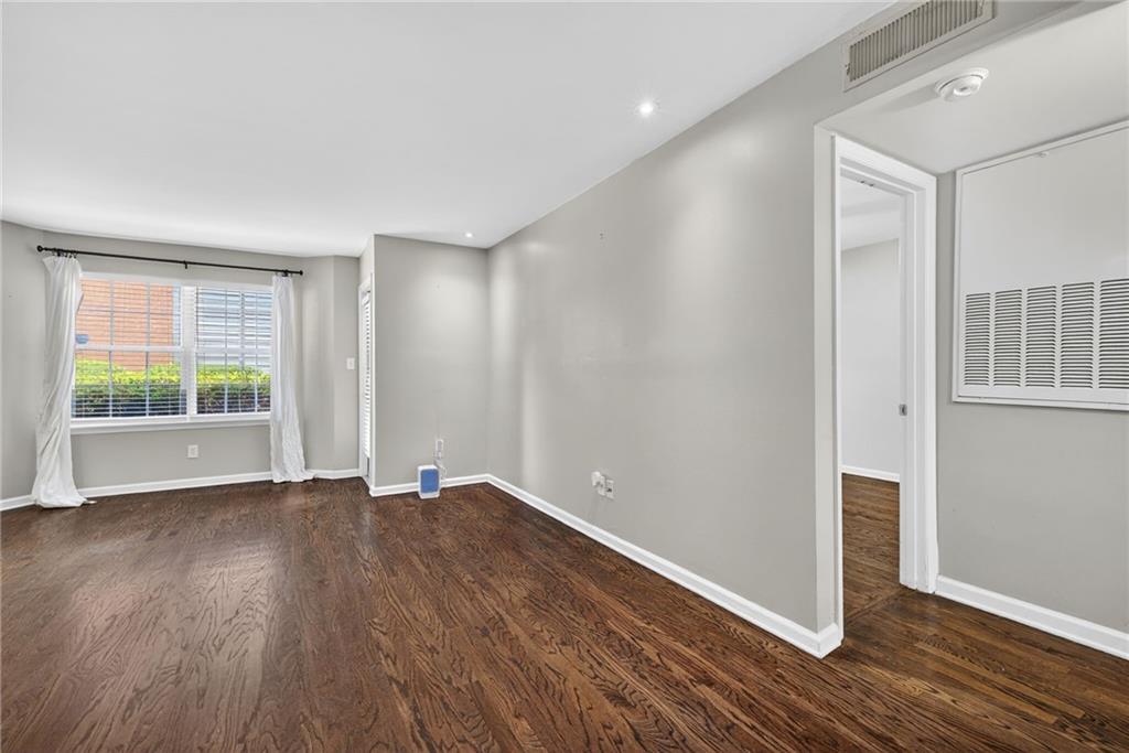 3063 Chastain Park Court Northeast Atlanta, GA 30342 - Photo 2 of 24 a view of an empty room with wooden floor and a window