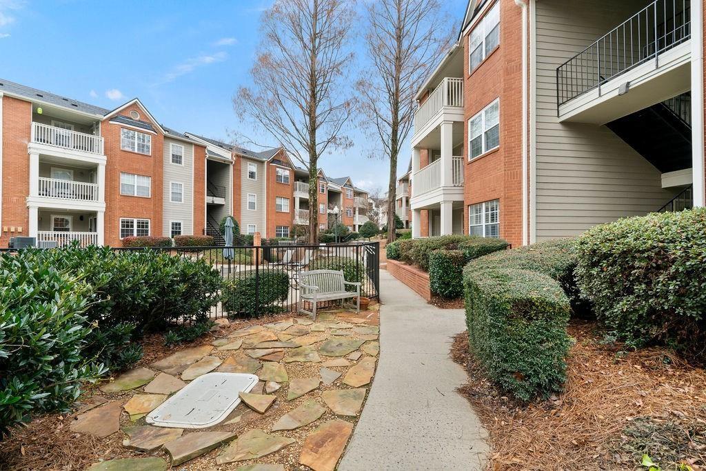3063 Chastain Park Court Northeast Atlanta, GA 30342 - Photo 21 of 24 a view of a patio with couches table and chairs potted plants and large tree
