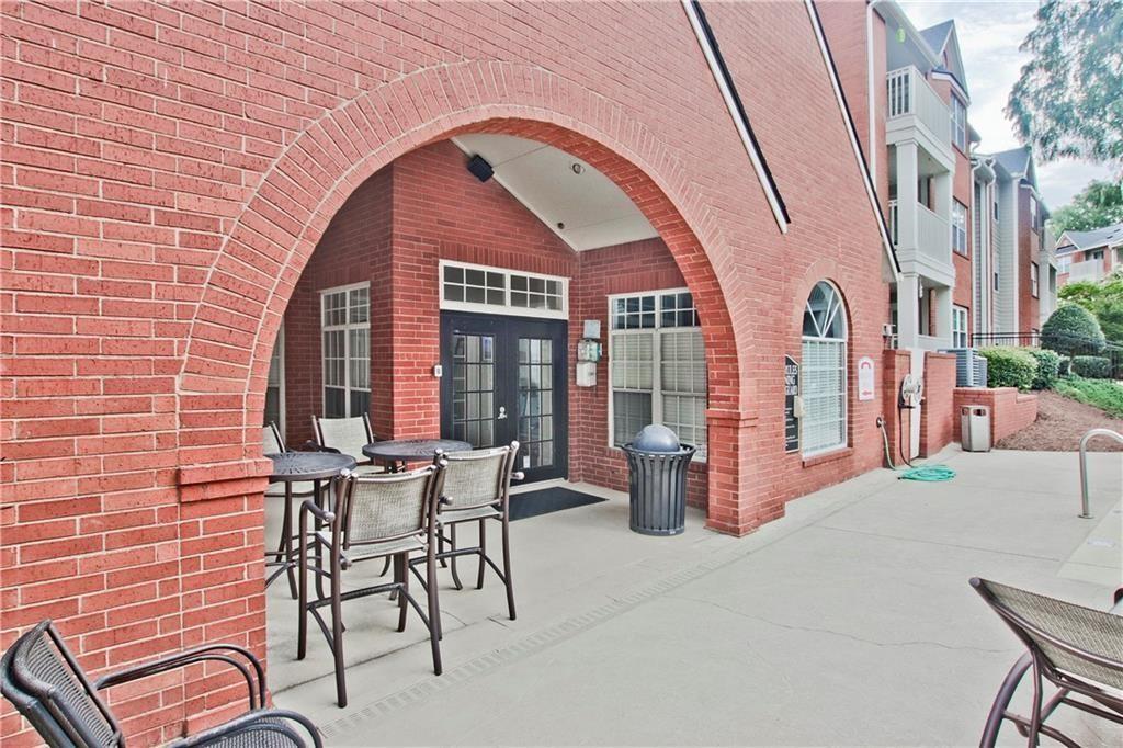 3063 Chastain Park Court Northeast Atlanta, GA 30342 - Photo 22 of 24 a front view of a house with outdoor seating