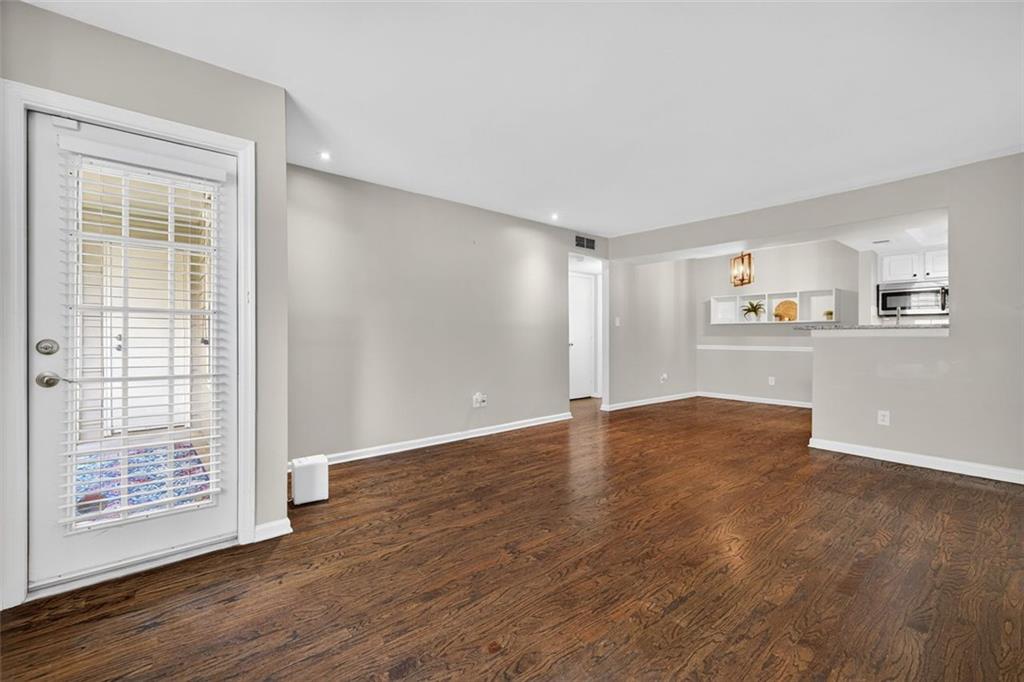 3063 Chastain Park Court Northeast Atlanta, GA 30342 - Photo 5 of 24 a view of empty room with wooden floor and window