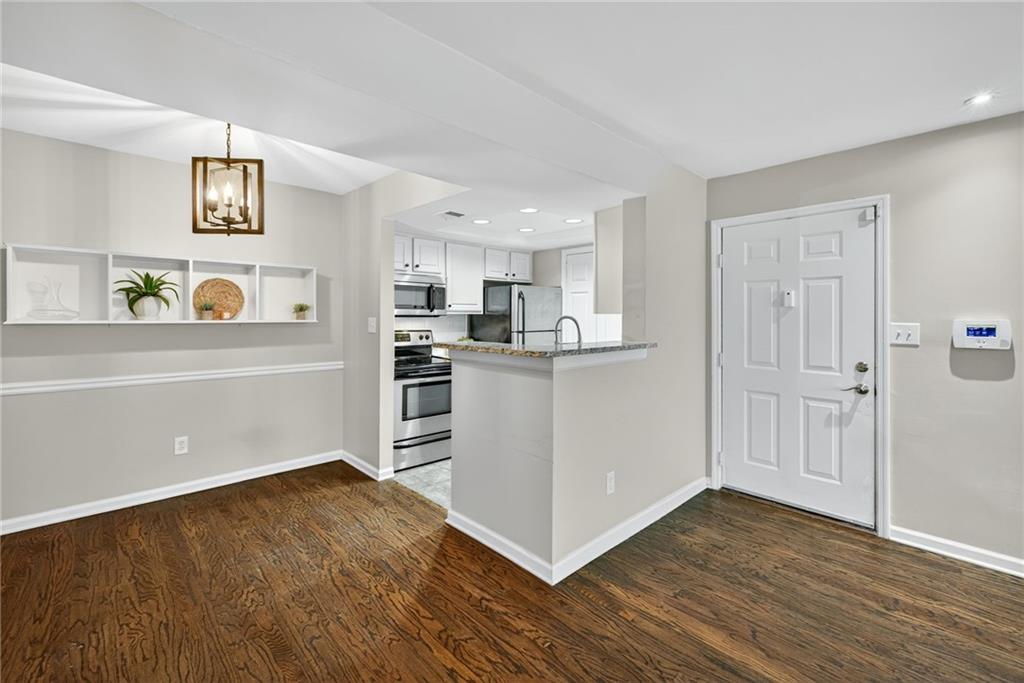 3063 Chastain Park Court Northeast Atlanta, GA 30342 - Photo 9 of 24 a view of a kitchen with wooden floor and electronic appliances