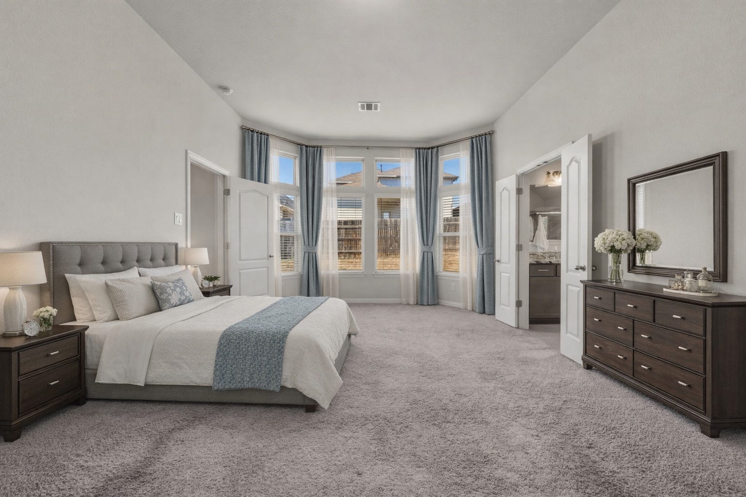 918 Leadtree Loop Buda, TX 78610 - Photo 15 of 27 Bedroom featuring light colored carpet and ensuite bath