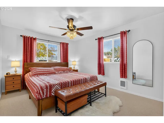 a bedroom with a bed table closet and window