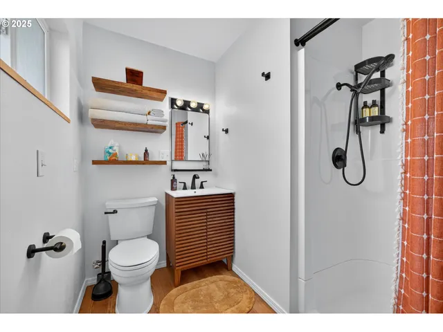 a bathroom with a toilet and a shower curtain
