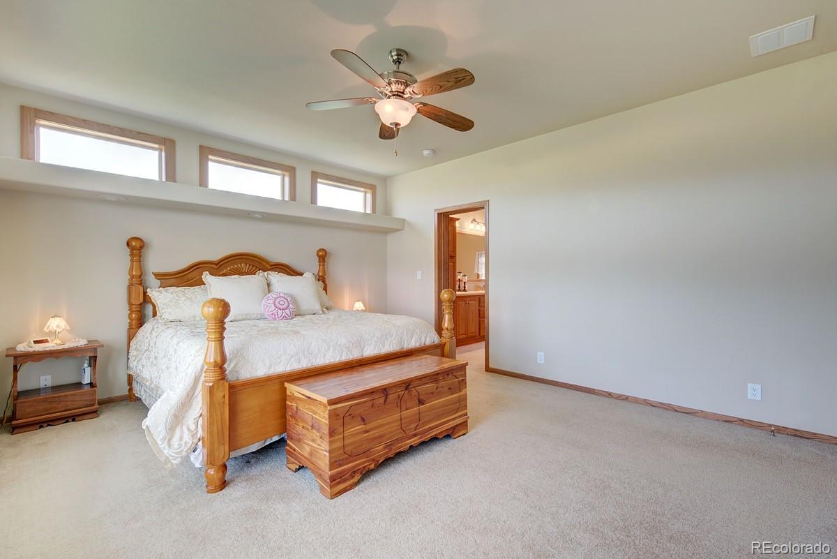 18045 Jones Road Peyton, CO 80831 - Photo 13 of 35 a bedroom with a bed and window