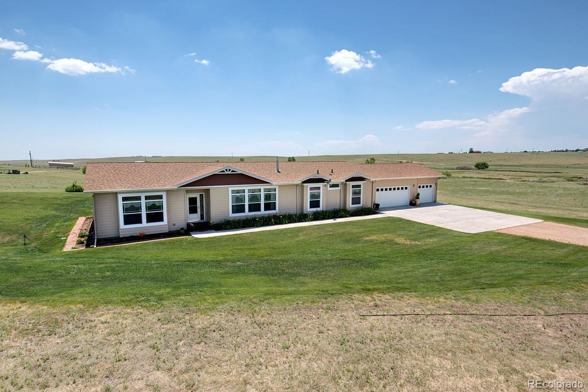 18045 Jones Road Peyton, CO 80831 - Photo 3 of 35 a balcony with table and chairs