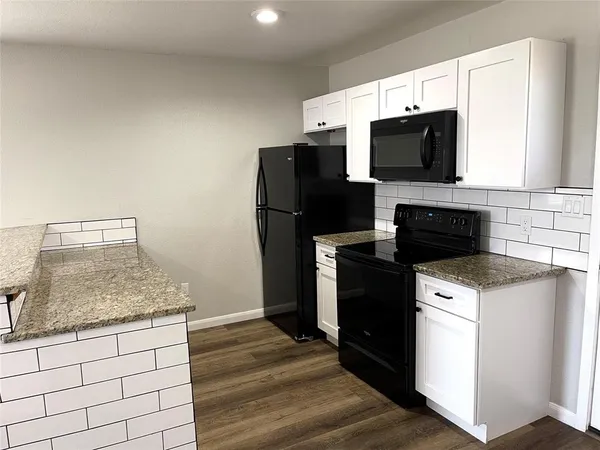 a kitchen with a sink stove and microwave