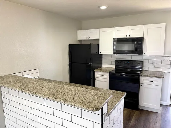 a kitchen with a stove and a refrigerator