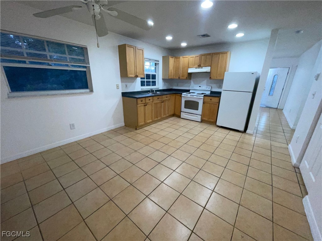 361 Bell Boulevard Lehigh Acres, FL 33974 - Photo 2 of 10 a kitchen with stainless steel appliances granite countertop a refrigerator and a stove top oven