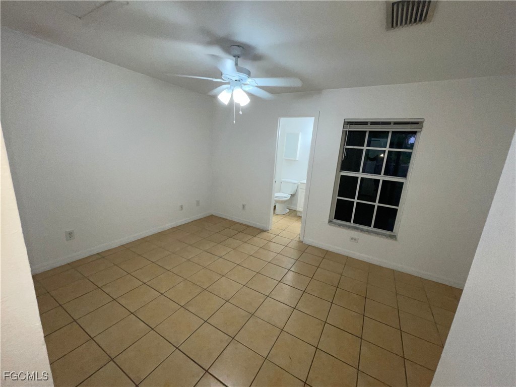 361 Bell Boulevard Lehigh Acres, FL 33974 - Photo 5 of 10 an empty room with windows