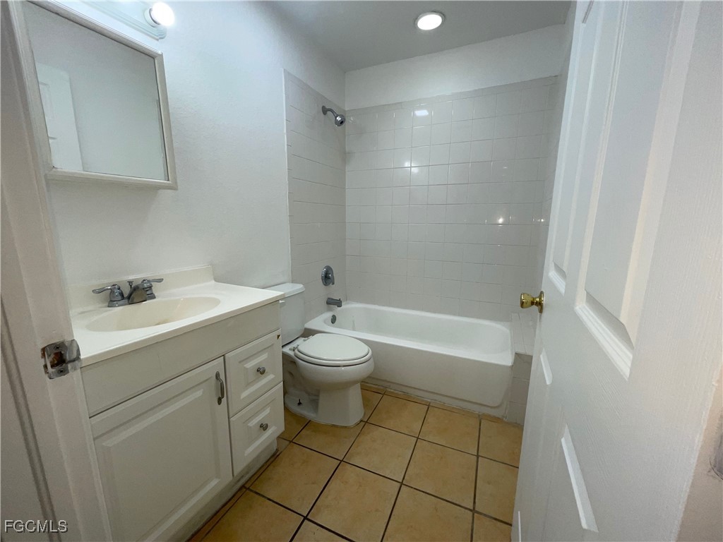 361 Bell Boulevard Lehigh Acres, FL 33974 - Photo 7 of 10 a bathroom with a sink a toilet and shower