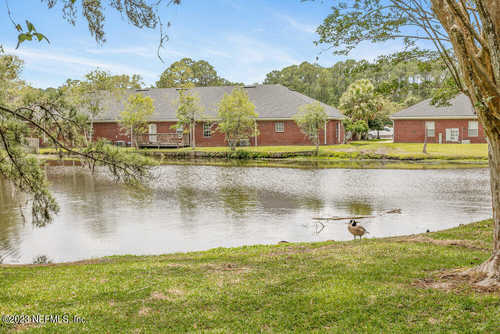3801 Crown Point Road, Unit 1134 Jacksonville, FL 32257 - Photo 30 of 38 a view of a lake with a building in the background