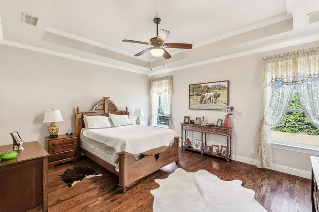 a view of a dining room and livingroom with furniture wooden floor a chandelier