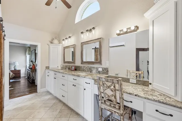 a bathroom with a granite countertop sink mirror and double