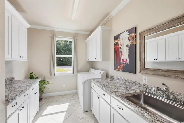 a bedroom with a bed and a large window with wooden floor