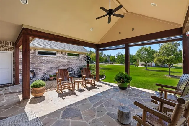 a kitchen with granite countertop a sink stove and cabinets