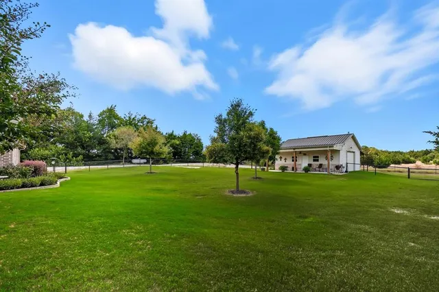 a view of a patio with a table chairs and a yard