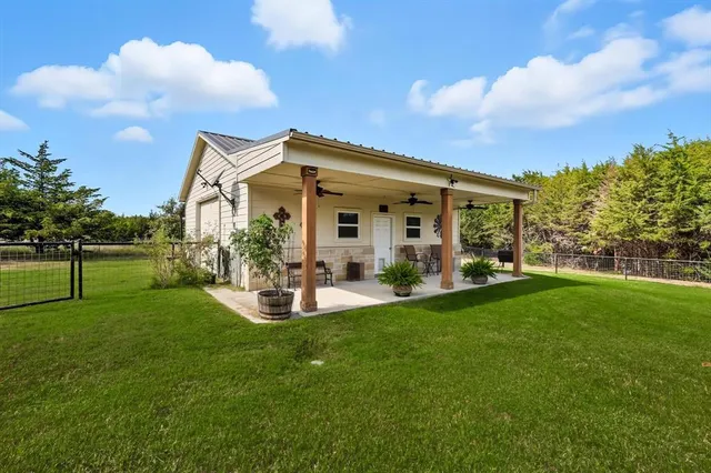 a view of a house with a backyard
