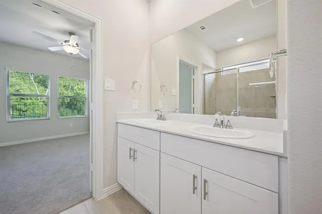 a bathroom with 2 sink and a mirror