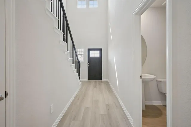 a view of a hallway with wooden floor and entryway