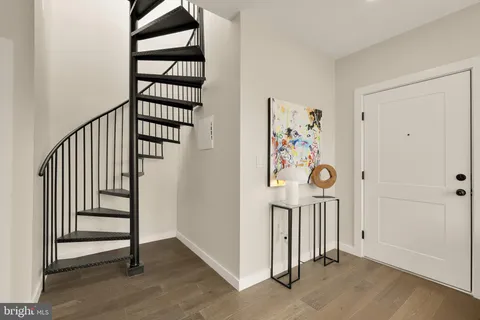 an entryway with a hallway to a room with stairs