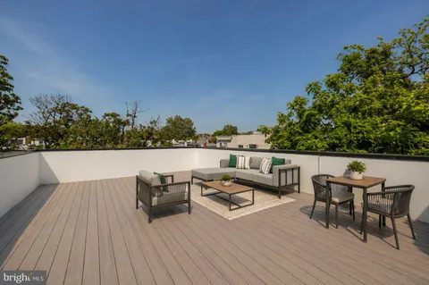a view of a terrace with couches and wooden floor