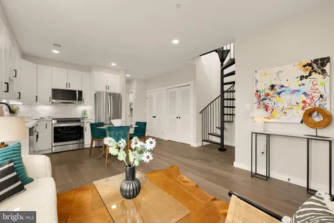 a living room with fireplace furniture and decor