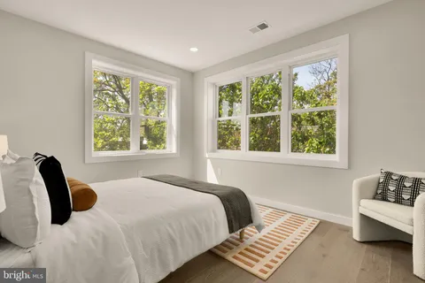 a bedroom with a bed and a large window