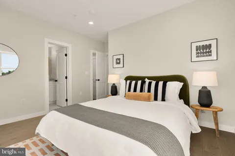 a bedroom with a double bed and a painting