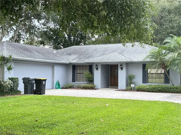 a front view of a house with a garden and plants