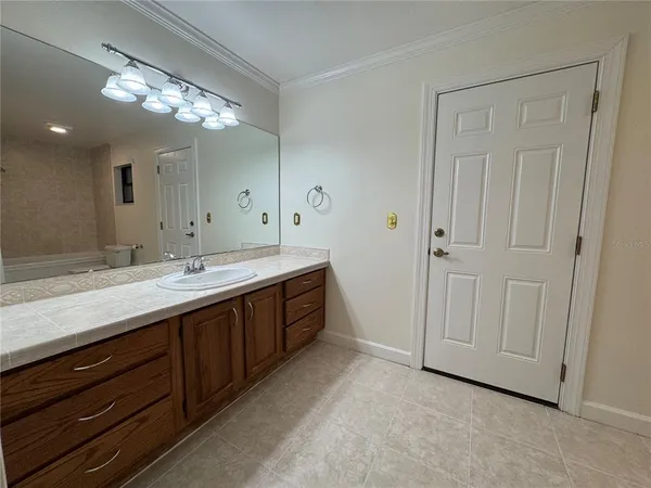 a spacious bathroom with a double vanity sink and a mirror
