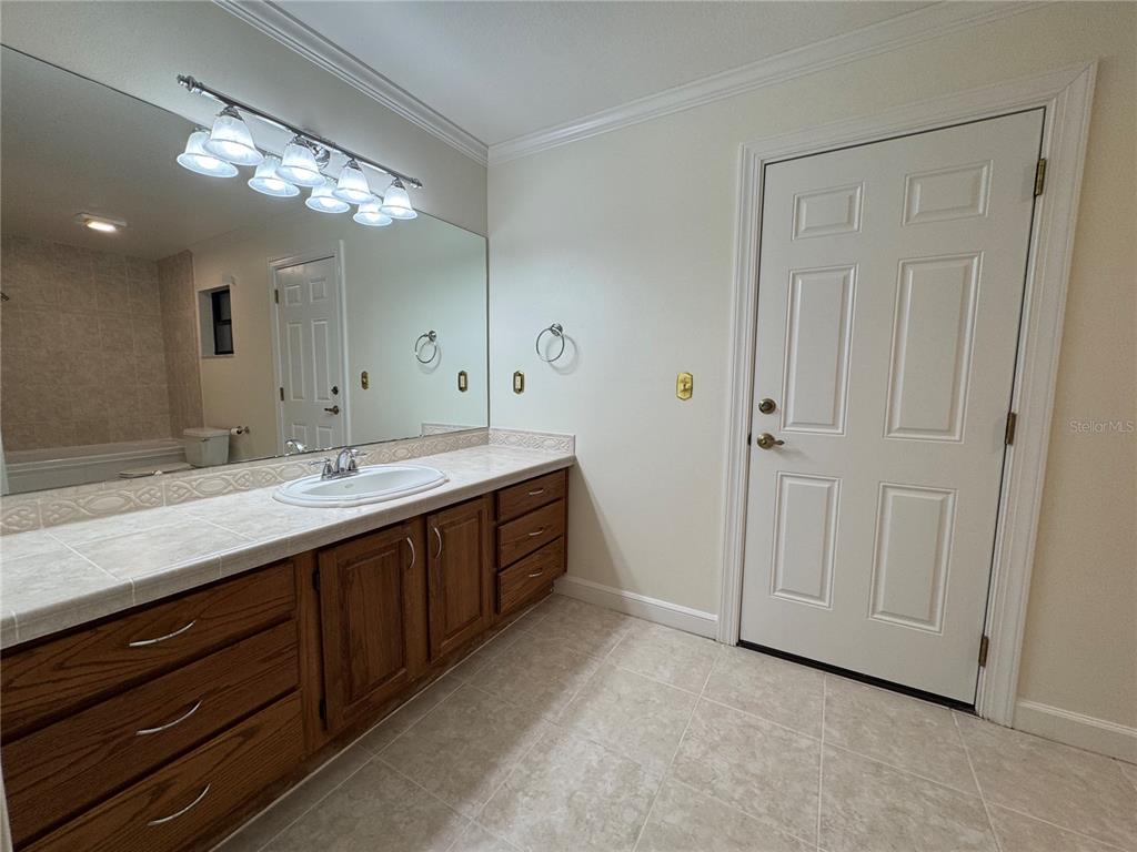 10 Fort Clinch Heights Road Frostproof, FL 33843 - Photo 19 of 40 a spacious bathroom with a double vanity sink and a mirror