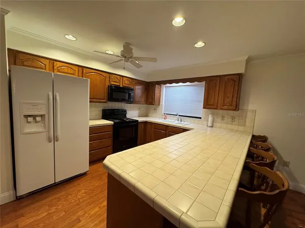a kitchen with stainless steel appliances a refrigerator and a stove top oven