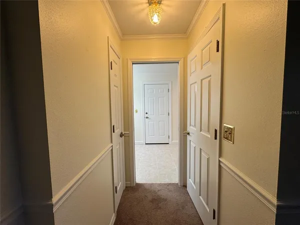 a view of a hallway with a wooden door