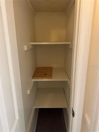 an empty room with wooden floor and ceiling fan