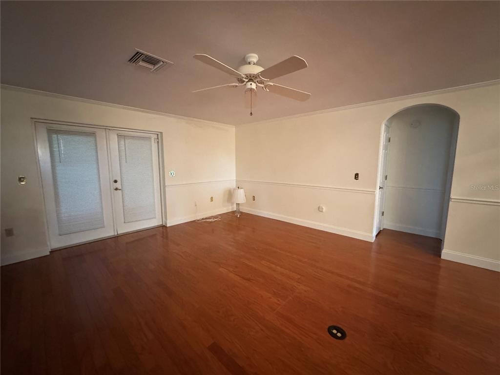 10 Fort Clinch Heights Road Frostproof, FL 33843 - Photo 24 of 40 an empty room with wooden floor and ceiling fan