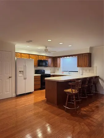 a large kitchen with stainless steel appliances granite countertop a large counter top and a stove