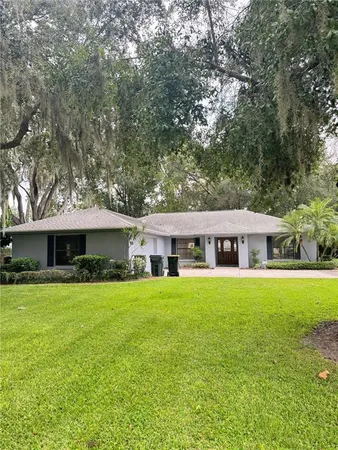 a front view of house with yard and green space