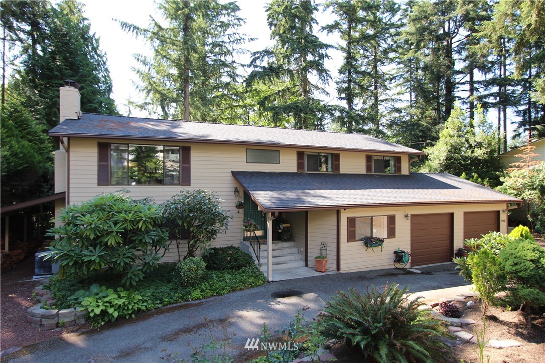 320 170th Place Southwest Bothell, WA 98012 - Photo 1 of 25 a front view of a house with garden
