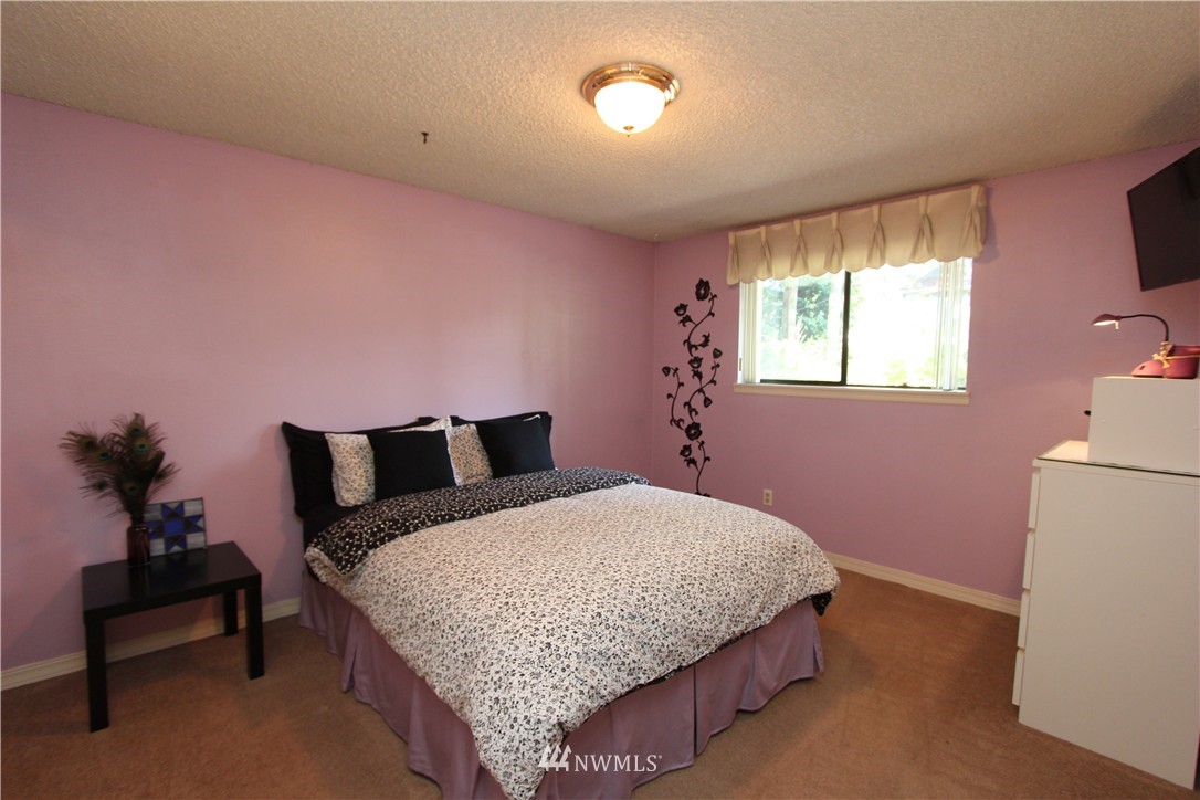 320 170th Place Southwest Bothell, WA 98012 - Photo 14 of 25 a bedroom with a bed and a dresser