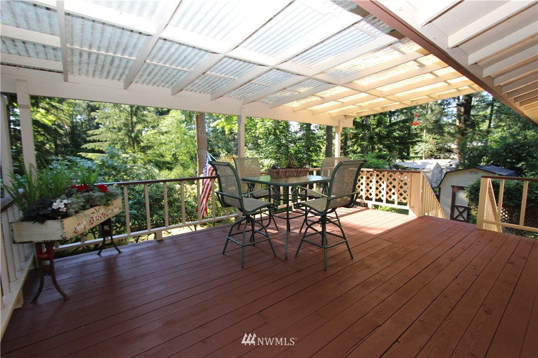 320 170th Place Southwest Bothell, WA 98012 - Photo 20 of 25 a view of a patio with table and chairs potted plants with wooden floor and fence