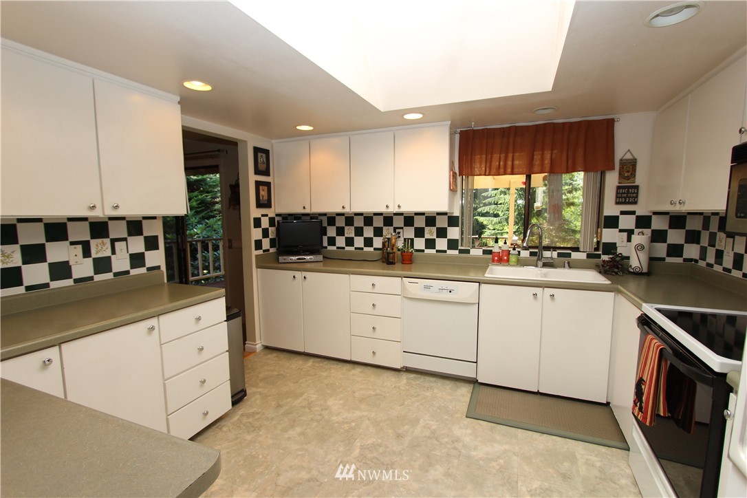 320 170th Place Southwest Bothell, WA 98012 - Photo 5 of 25 a kitchen with white cabinets and window